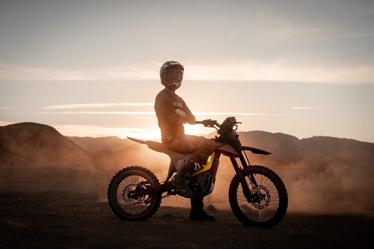 Rider on a NIU XQi silhouetted against the evening sun